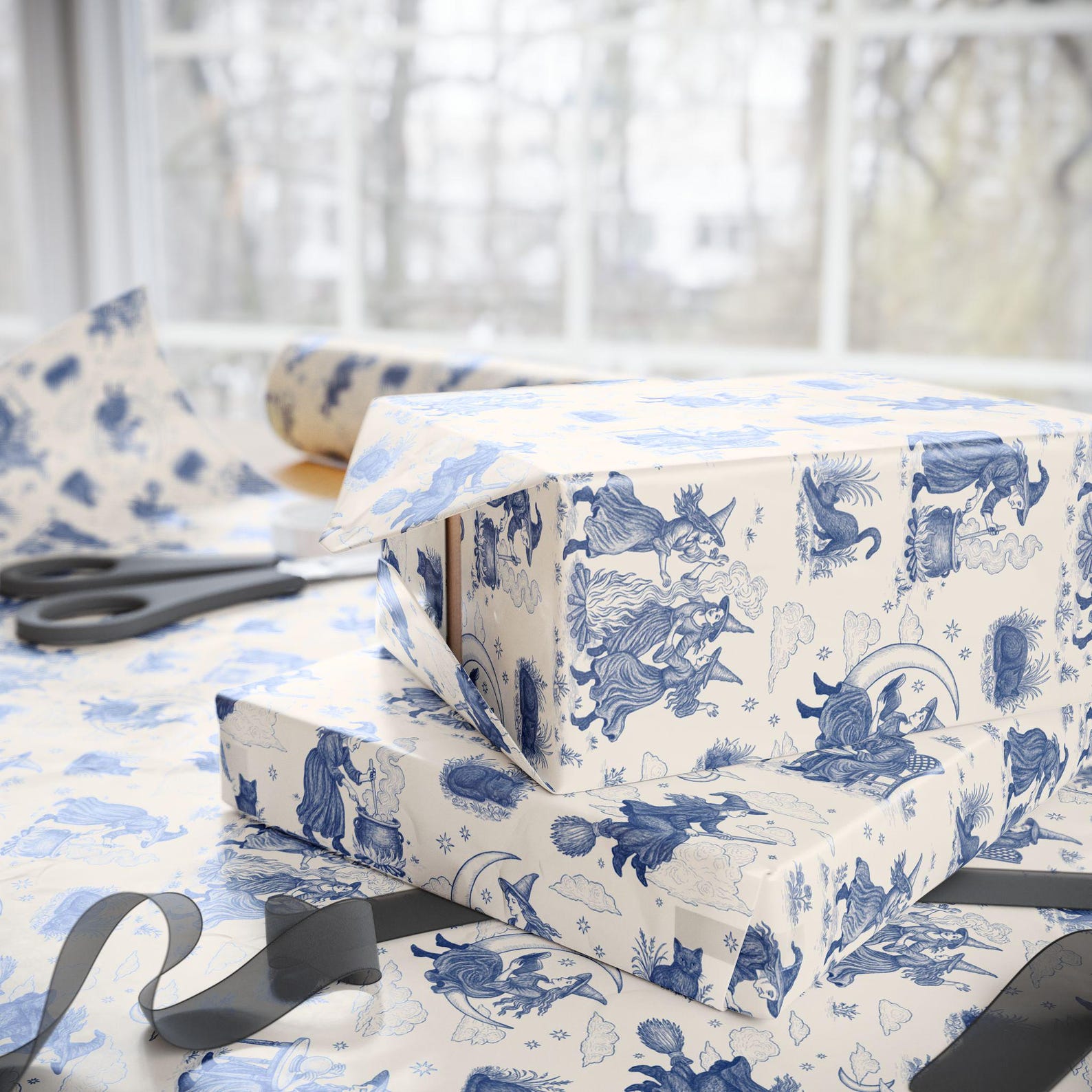 Gifts wrapped in cream Witch Toile de Jouy paper with blue illustrated witches
